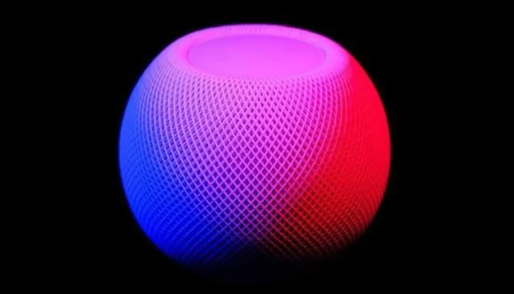 A sleek, spherical smart speaker glows in vibrant pink and blue hues against a black background, showcasing its modern design — revealing ways AI and accessibility can empower user experience.