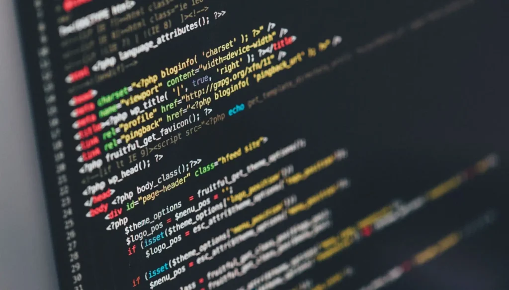 Close-up of computer code displayed on a dark screen, showcasing HTML and PHP syntax in various colors, illustrating the processes and challenges in Compliance Management Guide.