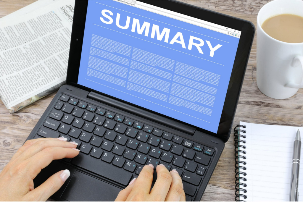 A person types on a laptop displaying "EXECUTIVE SUMMARY" on a blue background, surrounded by a newspaper, a notebook, and a coffee cup.